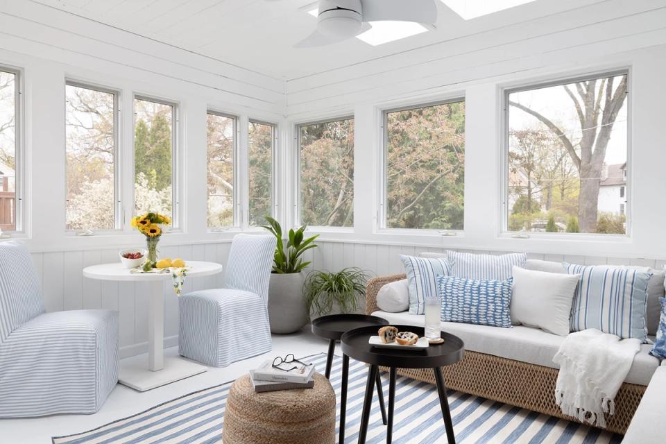 Modern farmhouse sunroom with crisp white accents, blue striping, and natural light