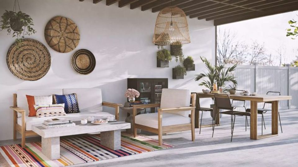 Bohemian rooftop retreat mixing woven wall art, natural wood furnishings, colorful accents, and global-inspired textures.