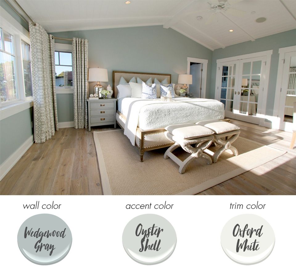 Serene coastal bedroom in pale blue-green with light wood and airy brightness
