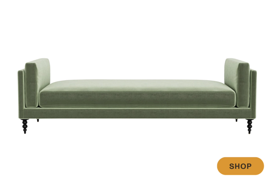 Elegant sage green daybed with turned legs and tailored upholstery