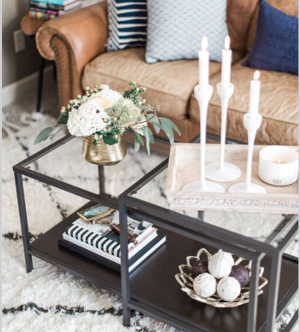 Classic caramel leather sofa with navy accents and curated coffee table styling