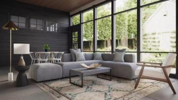 Scandinavian-inspired sunroom with dark charcoal walls, floor-to-ceiling windows, gray upholstery, and natural wood creating serene modern retreat.