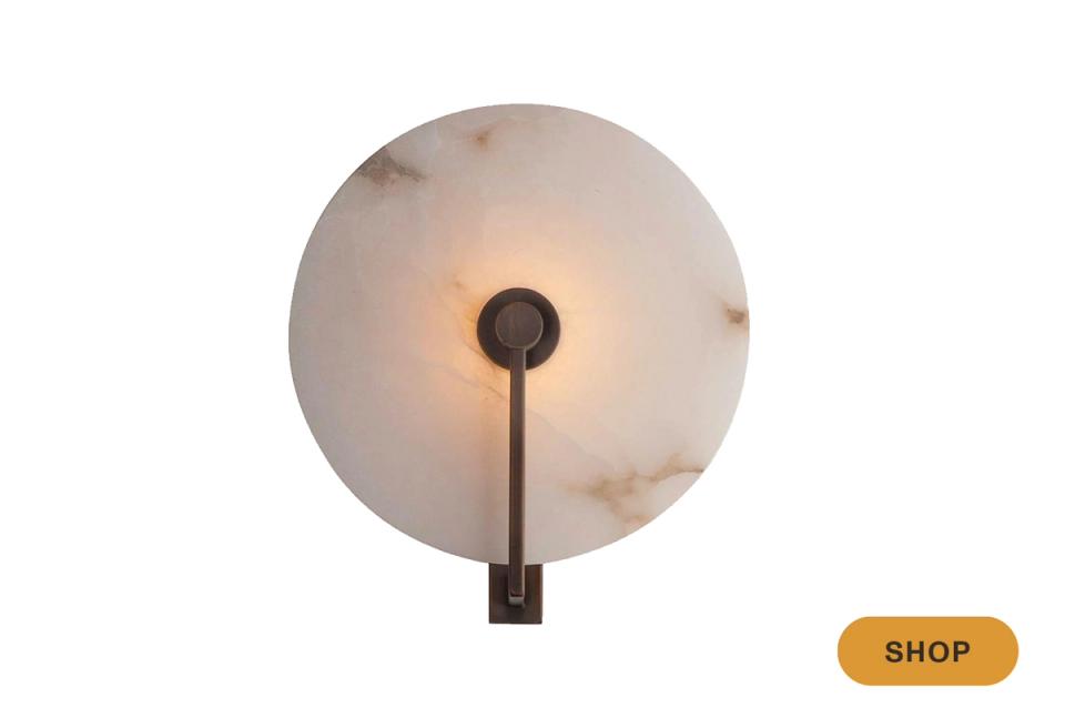 Organic modern alabaster disc wall light with blackened metal stem