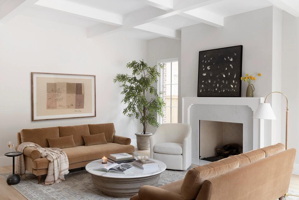 Warm layered living room with camel sofas, fireplace, and transitional style