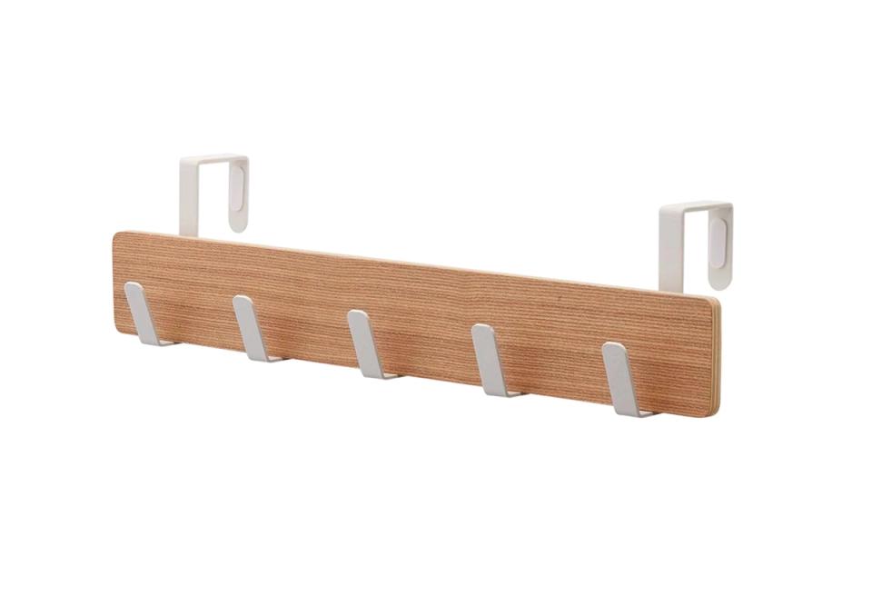 Warm wood wall organizer with silver hardware in Scandinavian style
