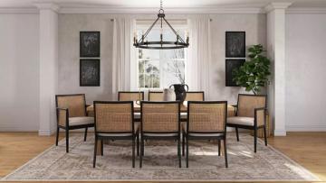 Classic coastal dining with black table, rattan chairs, neutral tones, and architectural details