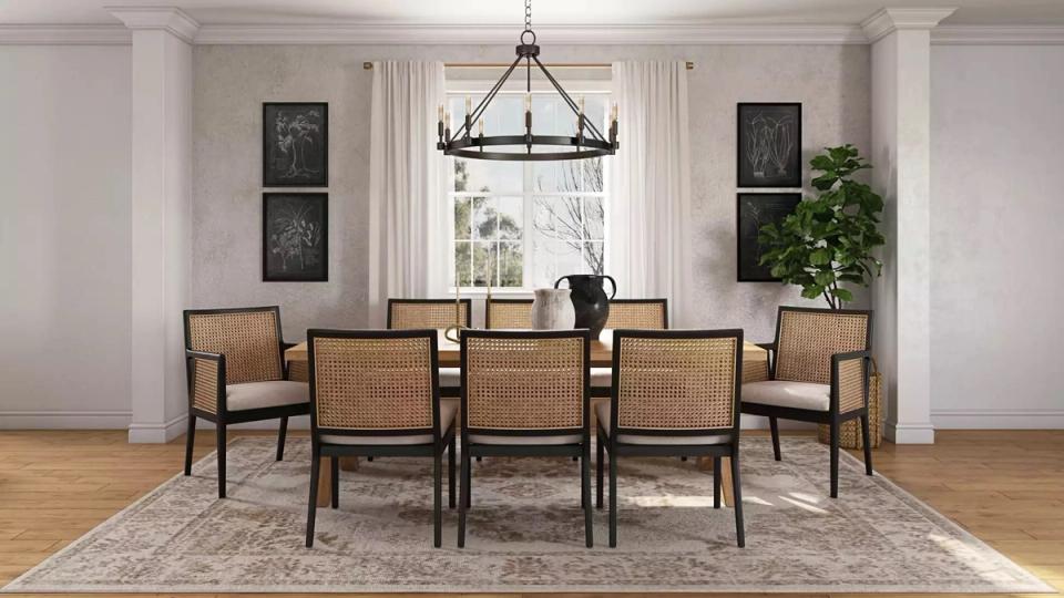 Classic coastal dining with black table, rattan chairs, neutral tones, and architectural details