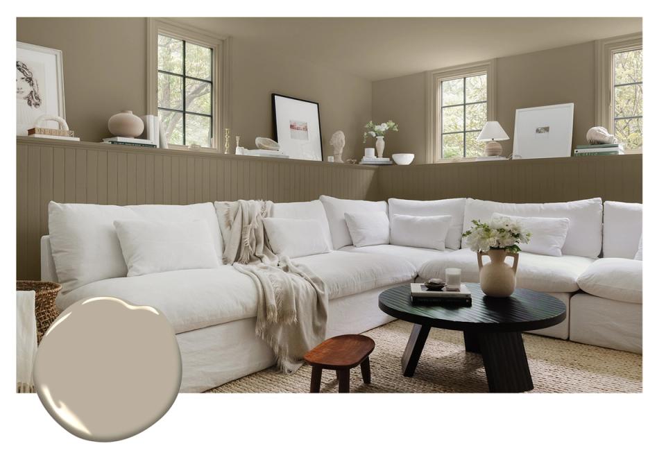 Serene living room with soft greige walls, cream sectional sofa, and minimalist decor emphasizing calm, contemporary comfort.