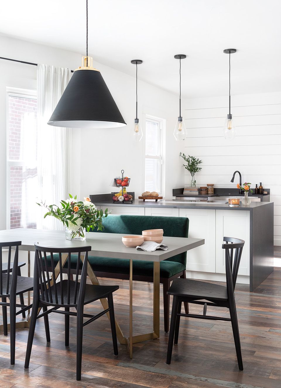 Contemporary kitchen with clean white shiplap moulding, black pendant lights, and modern Scandinavian design sensibility