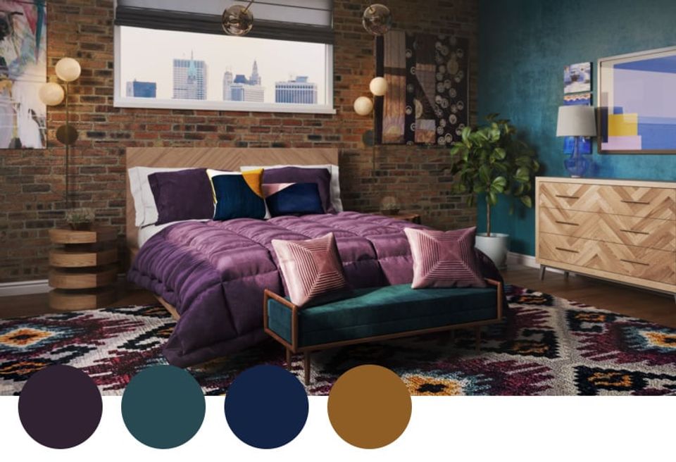 Moody bedroom with jewel-tone accents: deep purple bedding, teal accent wall, navy pillows, and warm brass fixtures creating luxe bohemian atmosphere.