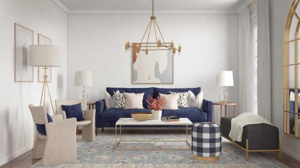Traditional style interior with navy sofa, cream accents, and patterned textiles anchored by brass pendant lighting and classic proportions.
