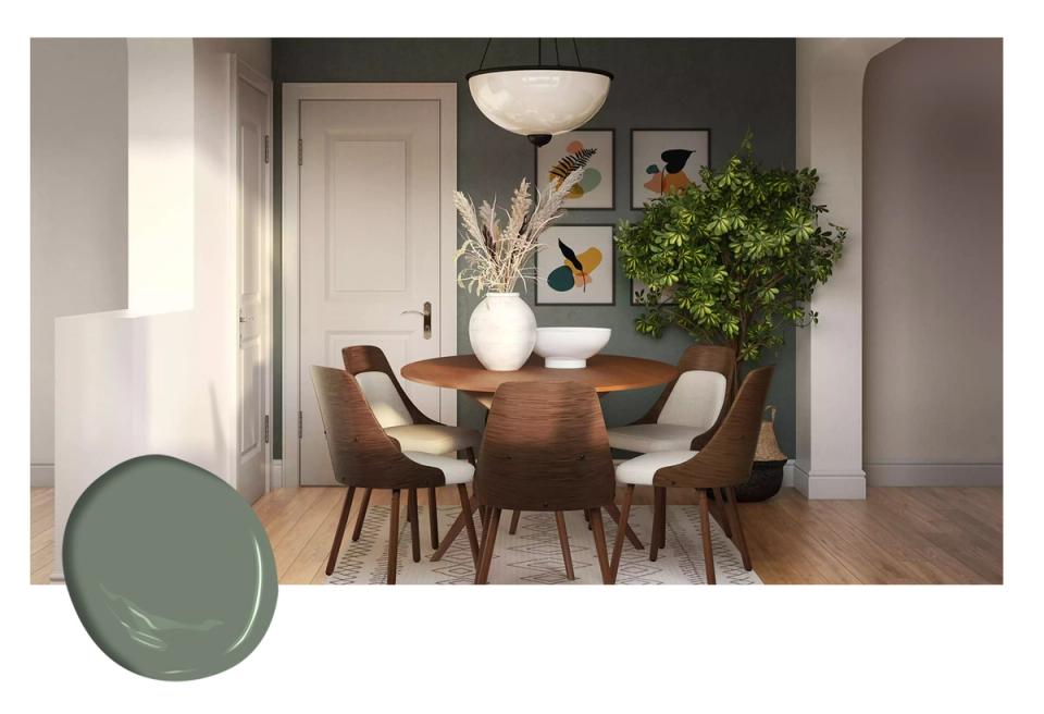 Serene dining space with soft sage walls, warm wood table, mid-century chairs, and botanical greenery creating calm sophistication