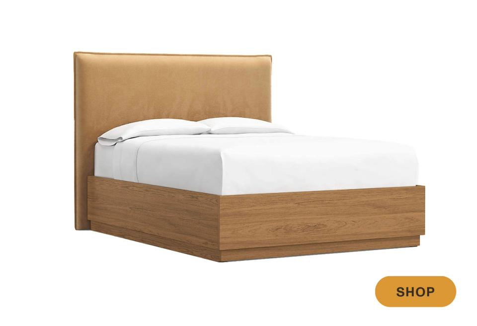 Mid-century modern storage bed combining natural wood frame with warm tan headboard