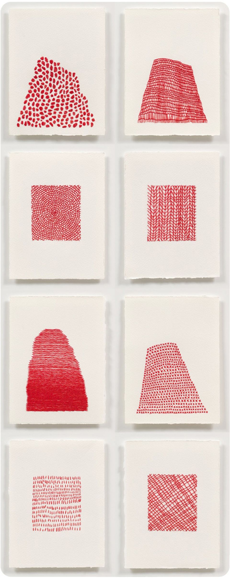 Gallery wall of abstract red and cream prints featuring geometric textile patterns and modern graphic art.