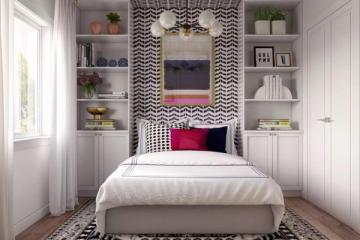 Contemporary bedroom with black and white geometric accent wall, built-in shelving, and pop of color for a modern, curated look.