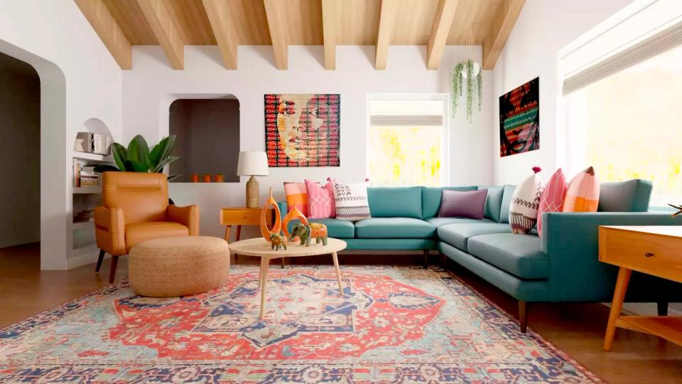 Eclectic mid-century modern living room with teal sofa, coral rug, and wood beam ceiling