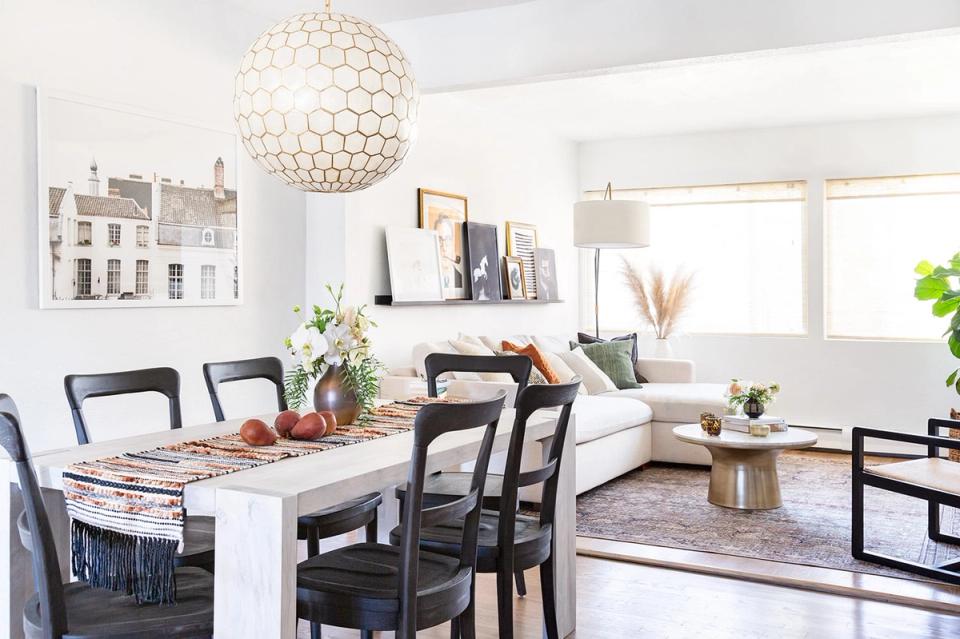 Transitional dining space blending Scandinavian simplicity with modern elegance, featuring light wood table and sophisticated neutral color scheme.