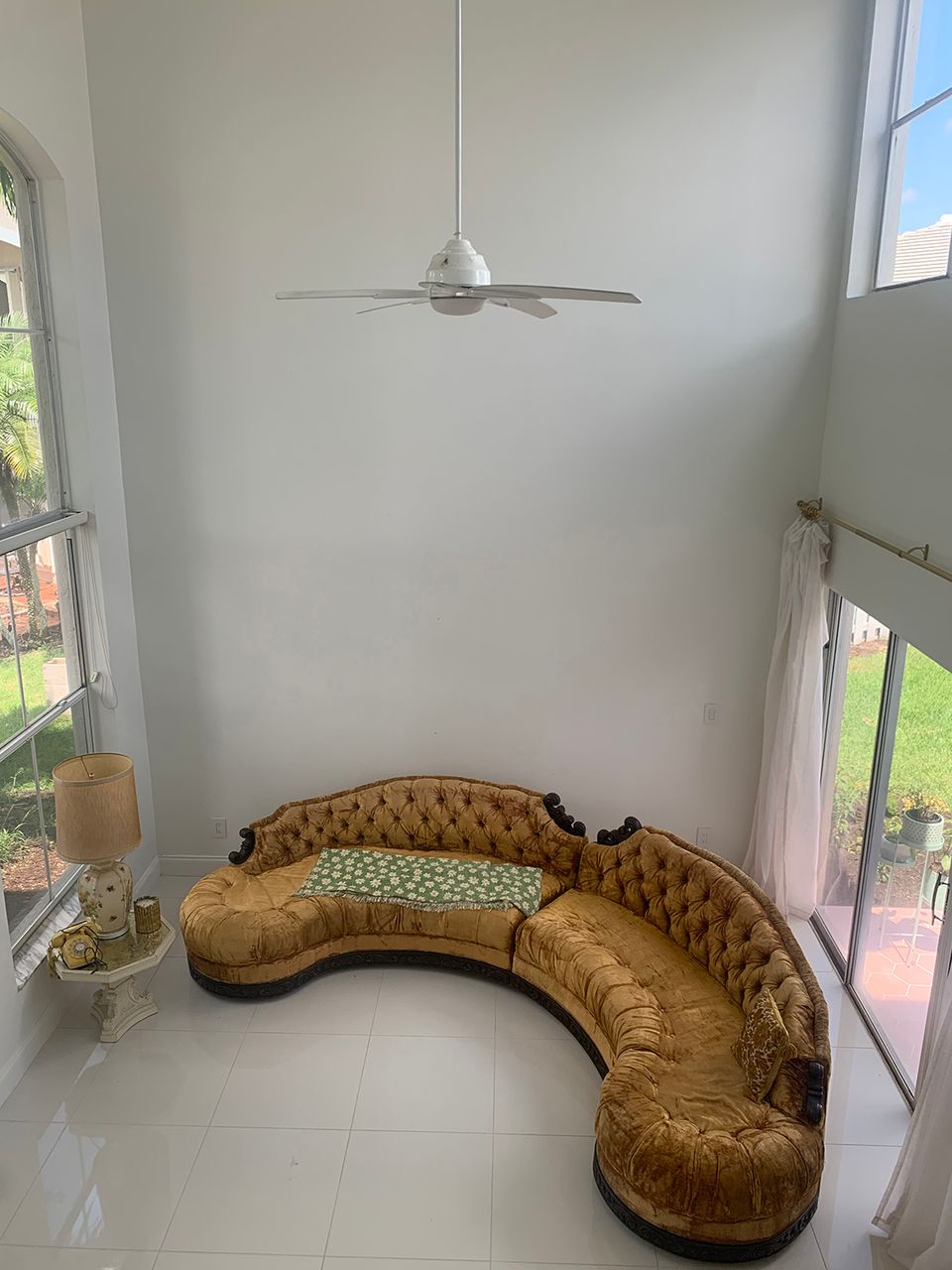 Contemporary living space with cognac leather curved sofa and floor-to-ceiling windows