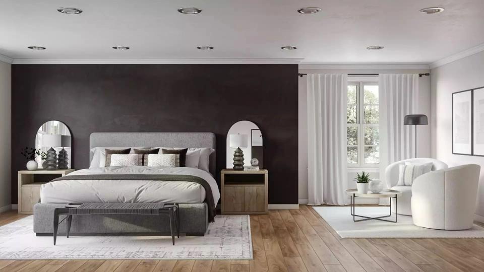 Contemporary bedroom featuring bold black accent wall, cream upholstered headboard, and warm wood flooring for dramatic yet elegant contrast.
