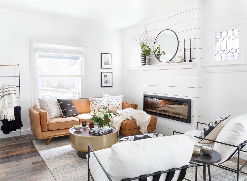 Modern minimalist space blending caramel leather, white shiplap, and functional wall-mounted styling