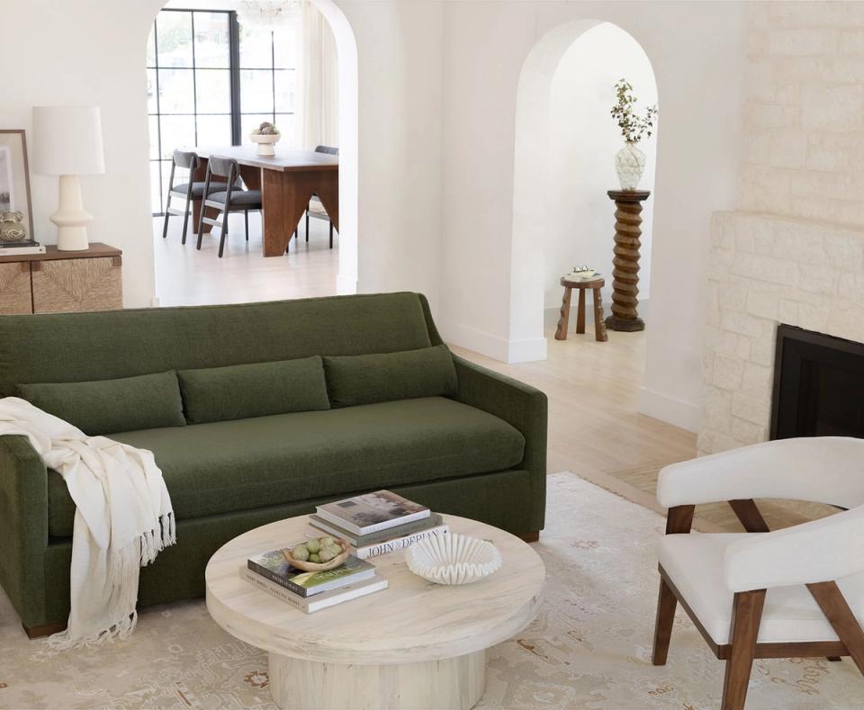 Modern living room with sage green sofa, light wood coffee table, and minimalist Scandinavian aesthetic
