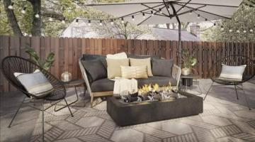 Contemporary patio with dark fire pit, cream seating, and geometric patterned rug