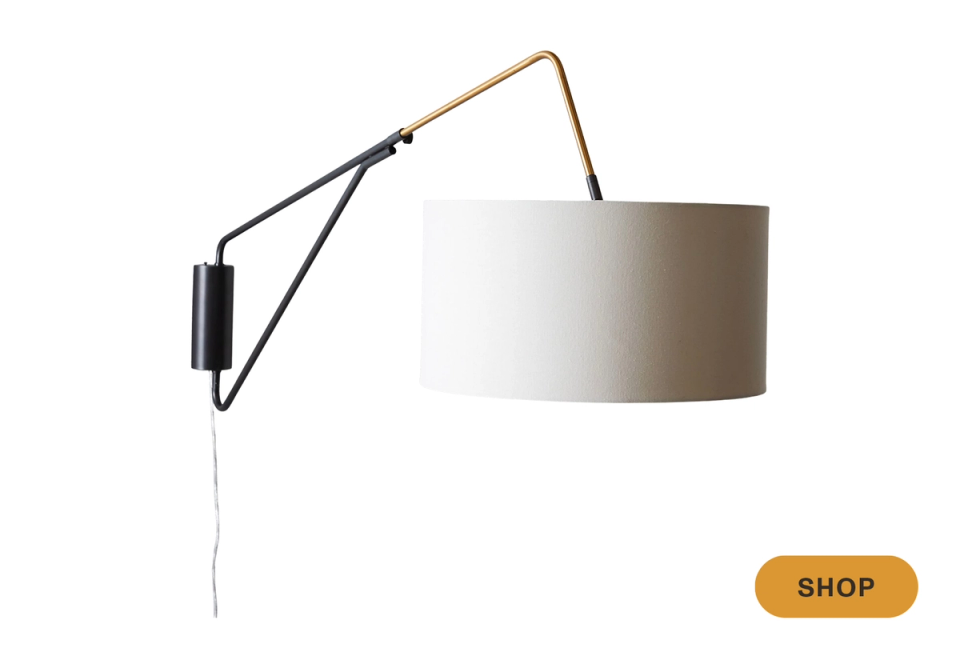 Contemporary swing-arm sconce with black frame and neutral linen shade