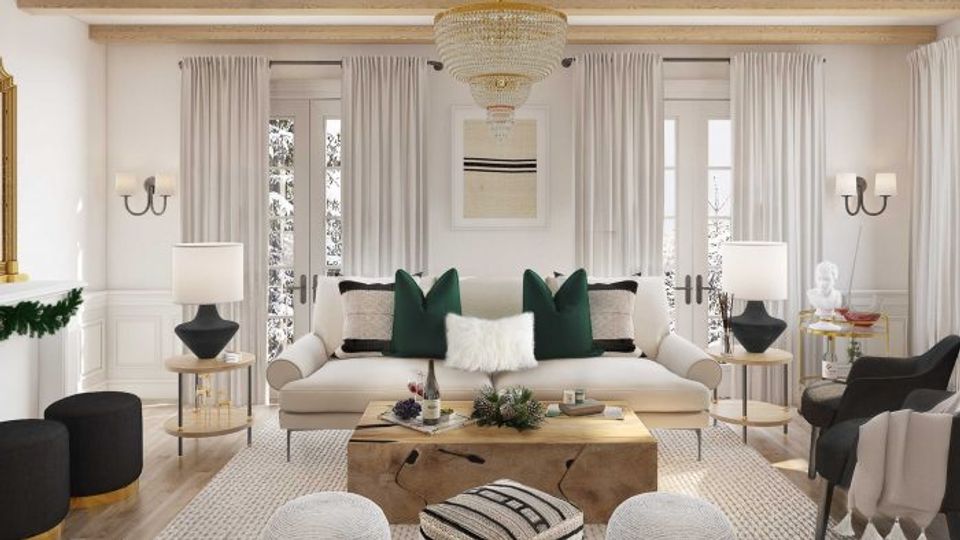 Sophisticated traditional living room in ivory and cream with emerald green pillows, brass accents, and floor-to-ceiling drapery