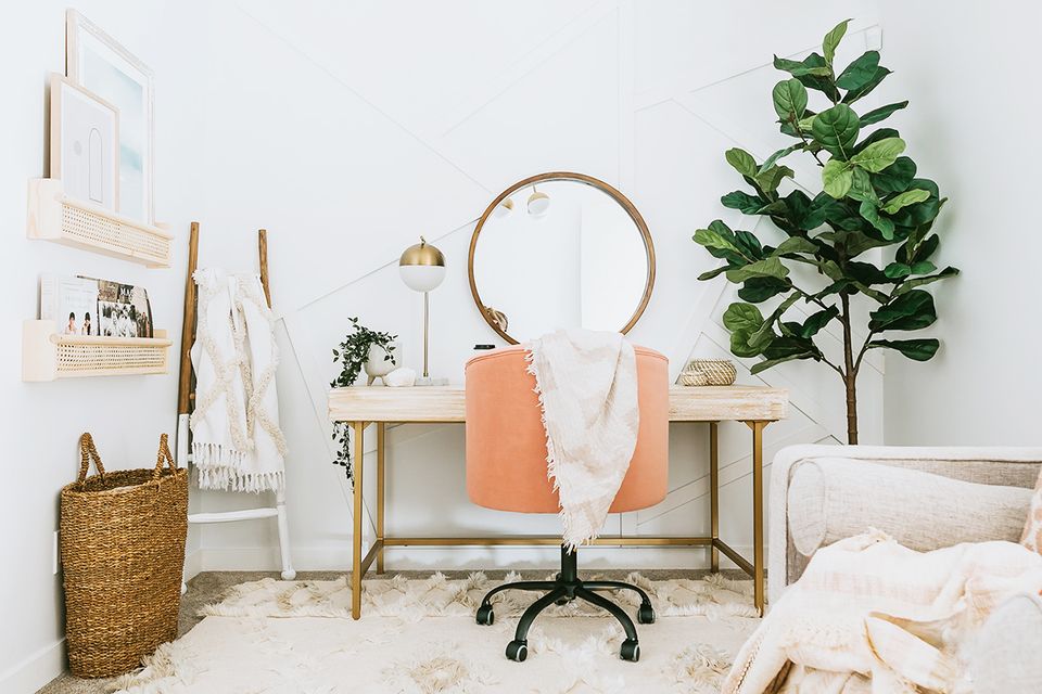 Scandinavian home office with warm wood desk, peachy accents, natural plants, and soft neutral palette