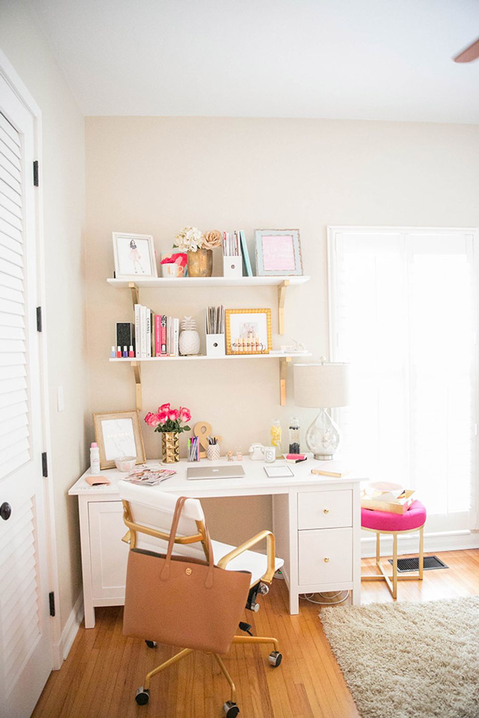 Bright study nook with floating shelves, white desk, natural wood tones, and soft pink accents