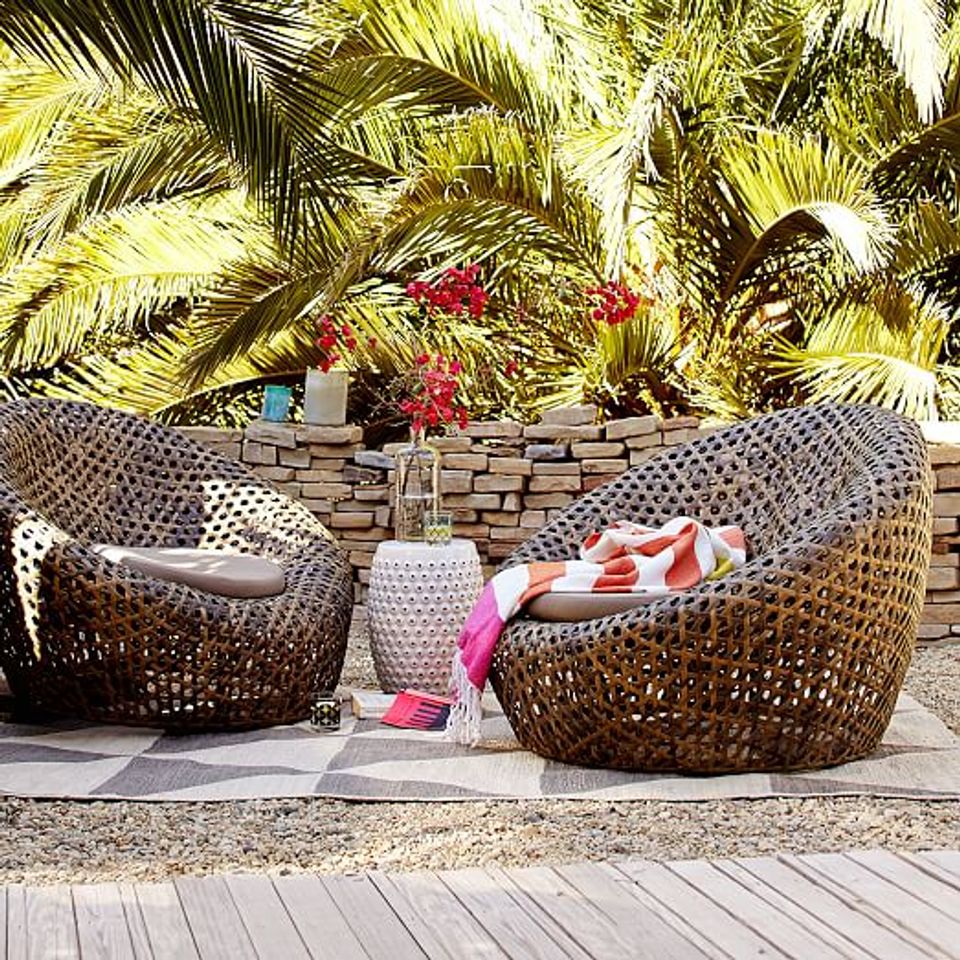 Tropical resort style, woven bucket chairs, vibrant blooms and palms