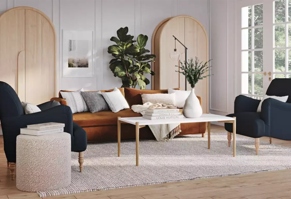 Contemporary living room blending warm wood, navy seating, and rounded mirror accents