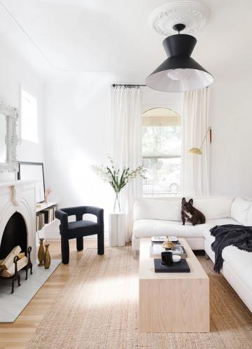 Minimalist monochromatic space with black and white contrast, natural light, and clean lines