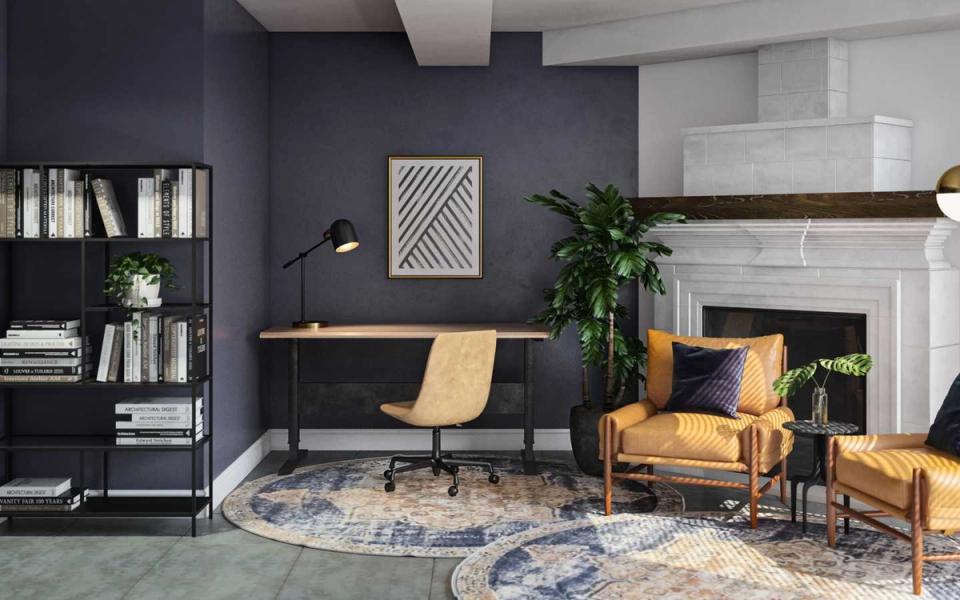 Modern transitional living room with deep navy walls, warm mustard mid-century chairs, white fireplace, and layered area rugs creating a sophisticated, balanced aesthetic.