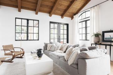Contemporary farmhouse interior with exposed beams, soft neutrals, and relaxed elegance