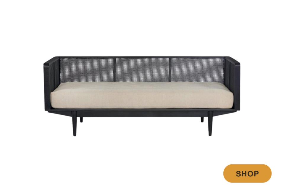 Mid-century modern daybed with black lacquered frame, gray panels, and cream cushion.