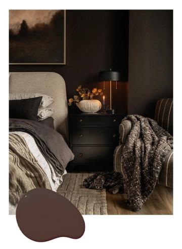 Moody bedroom with rich chocolate brown walls, cream upholstered headboard, and cozy layered textiles creating intimate, sophisticated atmosphere.