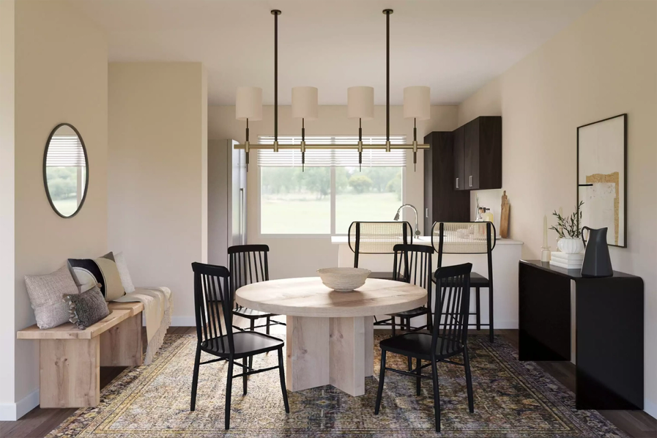Neutral contemporary dining room with round table, black Windsor chairs, and modern linear chandelier
