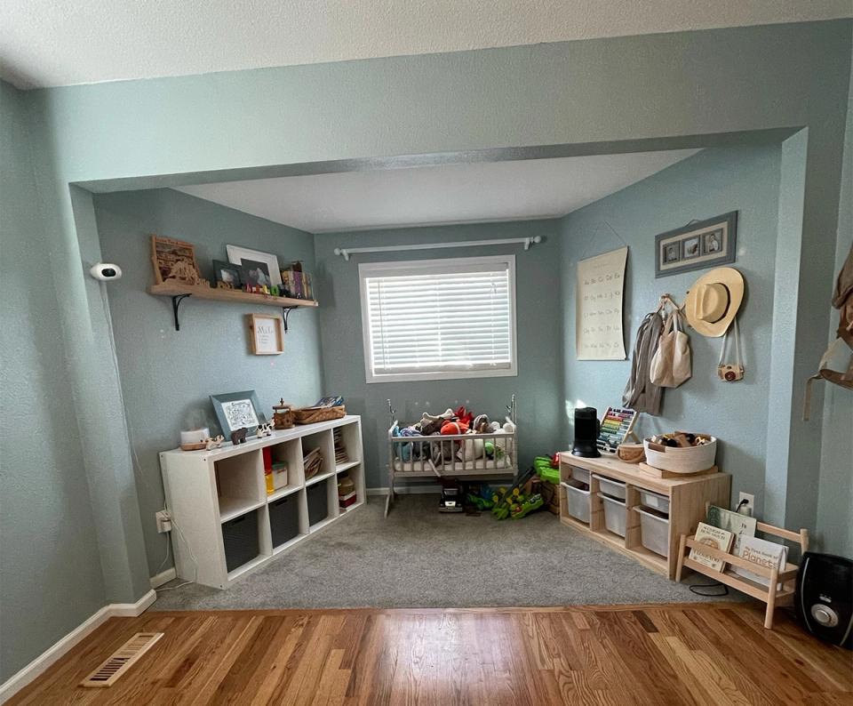 Calming mint-green playroom with open storage, natural wood accents, and organized play zones