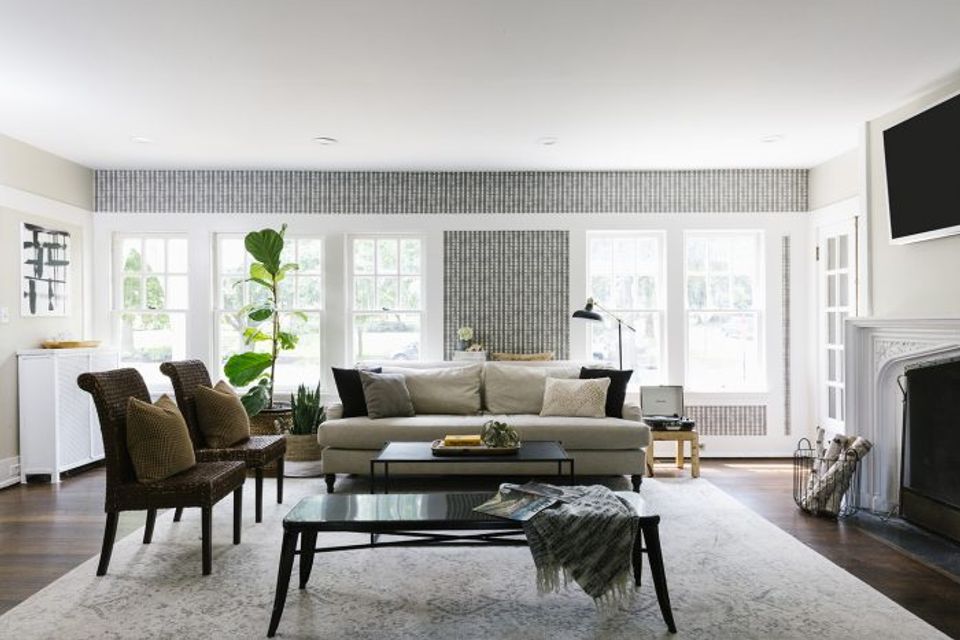 Scandinavian living room with subtle gray textured accent wallpaper, minimalist and serene mood.