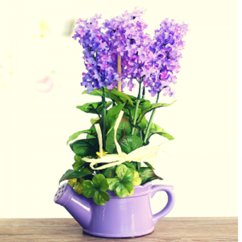 Whimsical purple arrangement: vibrant lilies in pastel purple teapot planter, playful eclectic design