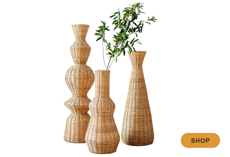 Natural woven vases in graduated heights with organic botanical greenery styling