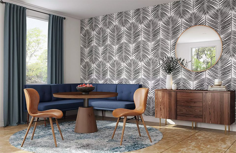 Mid-century modern dining space with navy curved sofa, geometric patterned wallpaper, and warm wood accents