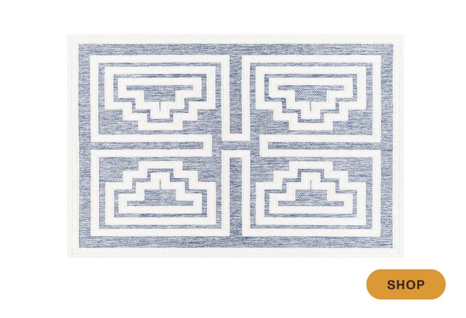 Modern geometric rug with blue and white quatrefoil design in four sections
