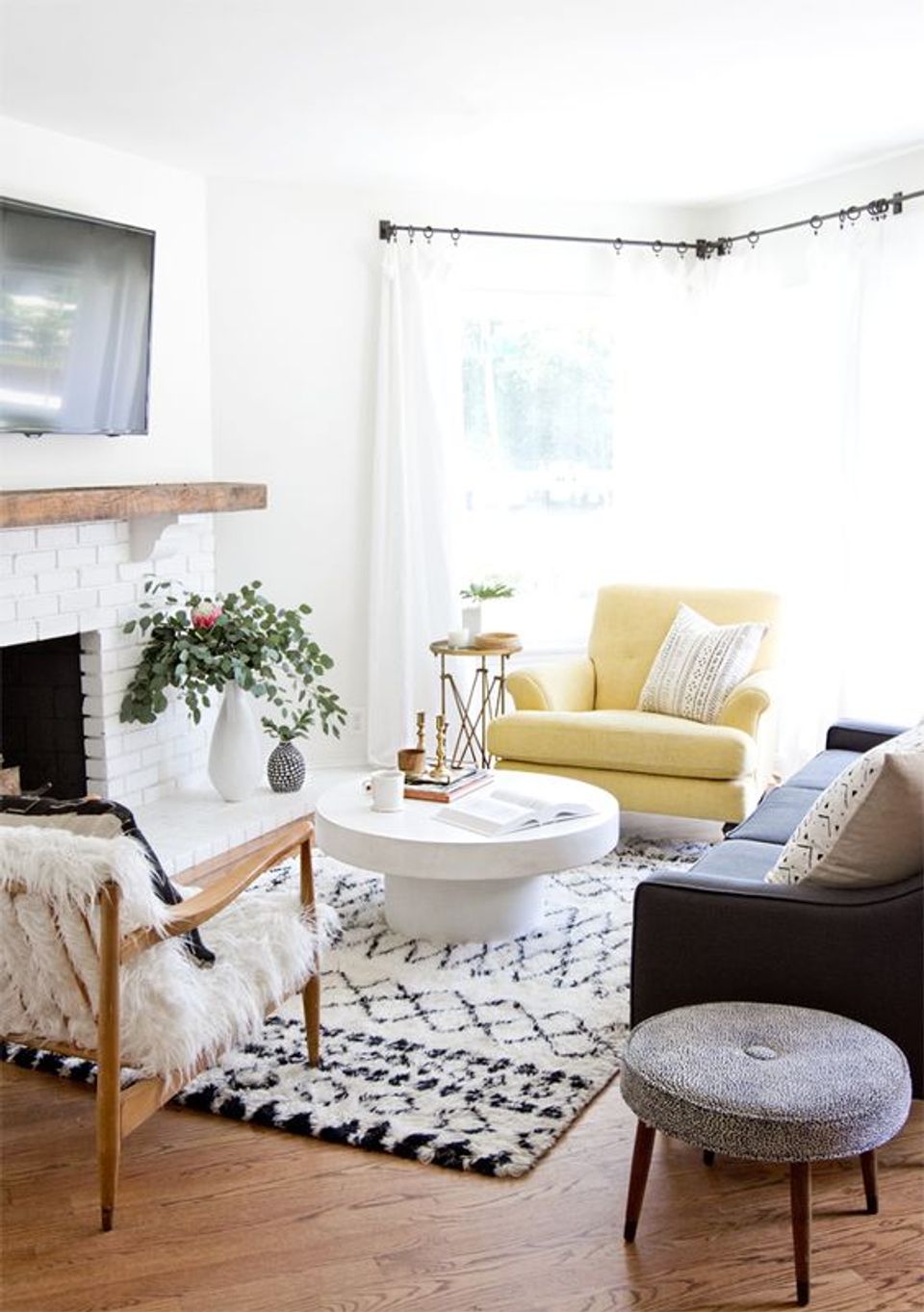 Contemporary eclectic space with cheerful yellow chair, mixed textures, and botanical elements for serene charm