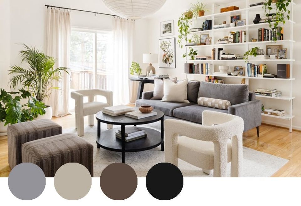 Light-filled modern living room with gray sofa, built-in shelving, lush greenery, and warm taupe accents balanced with crisp whites and blacks.