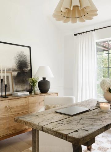 Minimalist home office with pale wood, sculptural pendant, and serene monochrome palette