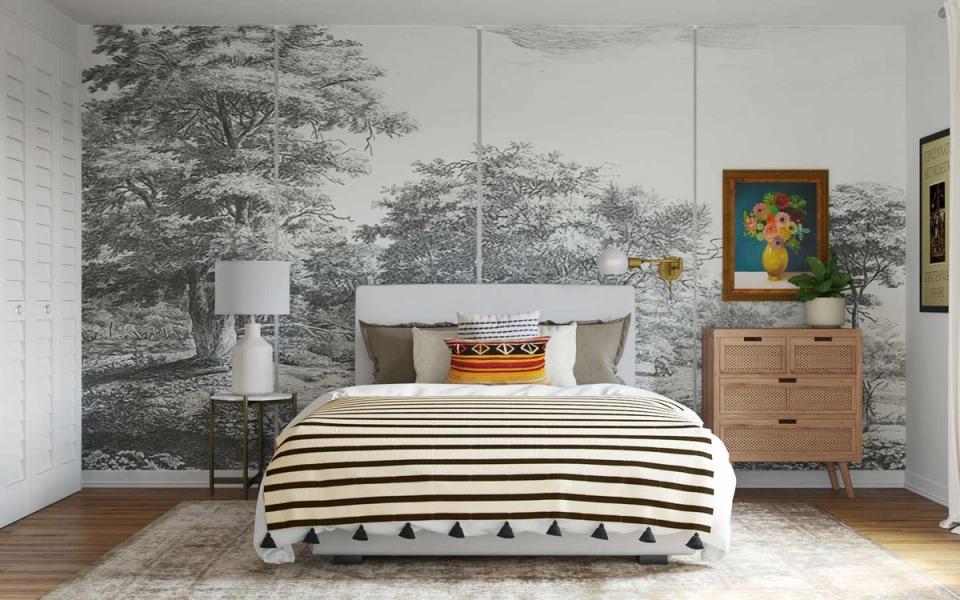Eclectic bedroom with botanical wallpaper, striped bedding, natural wood furniture, and gallery wall art creating cohesive vintage-modern style.