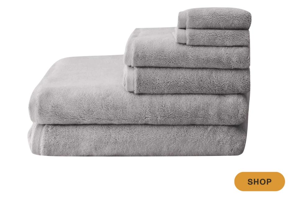 Soft gray towel collection in varying sizes, calming neutral palette with plush texture
