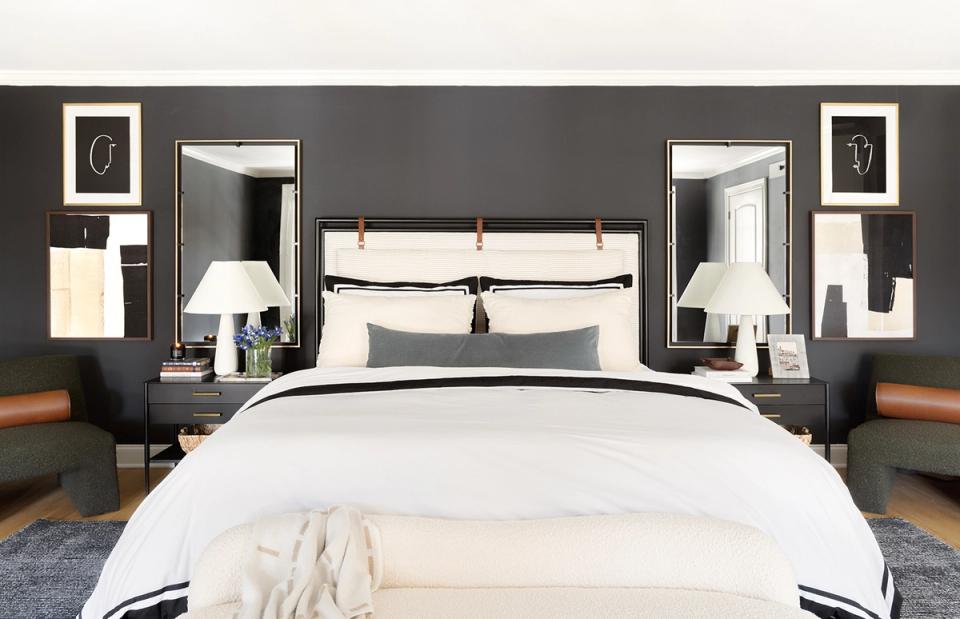 Sophisticated dark gray bedroom with crisp white linens, symmetrical nightstands, and warm wood tones
